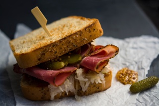 Sandwich with pickles, smoked meat and sauerkraut