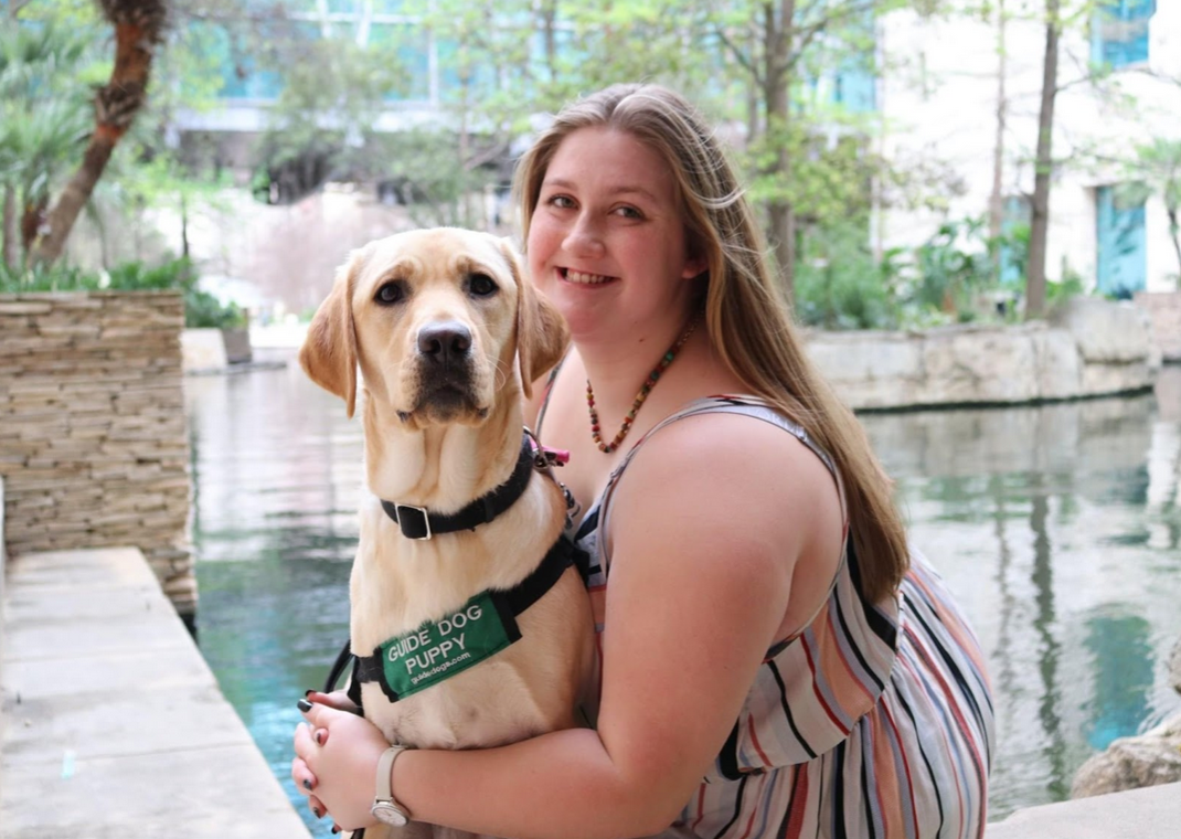 Shell (left) and Sierra (right) posed in front of the Riverwalk in San Antonio, Tx. Shell is in her GDB vest.