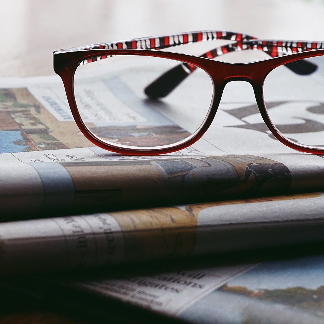 Glasses lying on newspapers